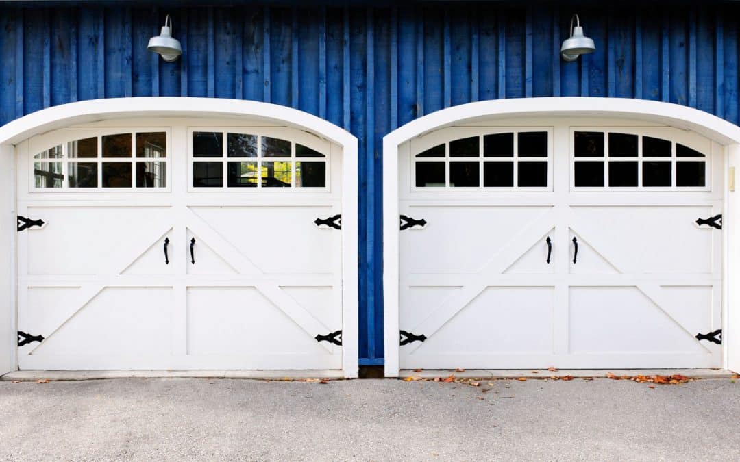 White doors with decorative garage door hardware